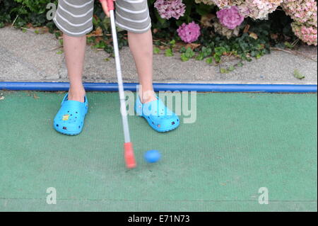 English children playing crazy golf in Newquay, Cornwall, Uk Stock Photo