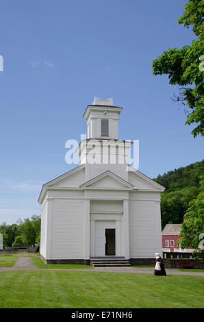 USA, New York, Cooperstown, Farmers' Museum. Open-air rural museum. Cornwallville Church. Woman in period attire. Stock Photo