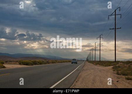 Storm clouds rolling in on the Mojave desert highway - California USA Stock Photo