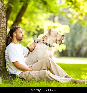 Man and Dog Argentino walk in the park. Stock Photo