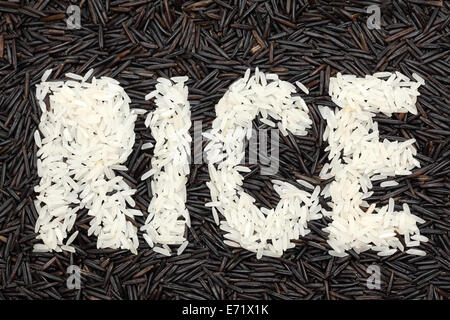 Word 'RICE' written with white rice on a wild rice background. Closeup. Stock Photo