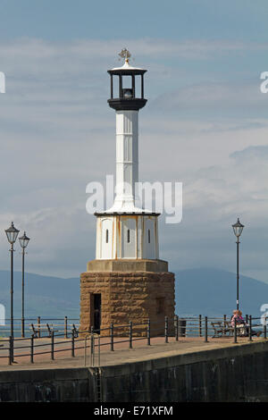 Historic 18th century lighthouse on harbour wall at coastal town of Maryport in Cumbria England Stock Photo