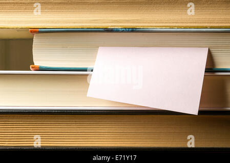 Close-up of a pile of books for studies, with a post-it paper note Stock Photo