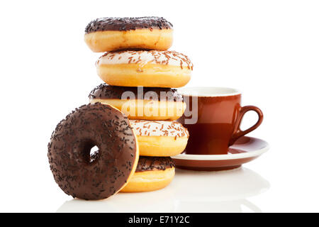 Stacked dark and white chocolate sprinkle donuts and coffee cup isolated on white background Stock Photo