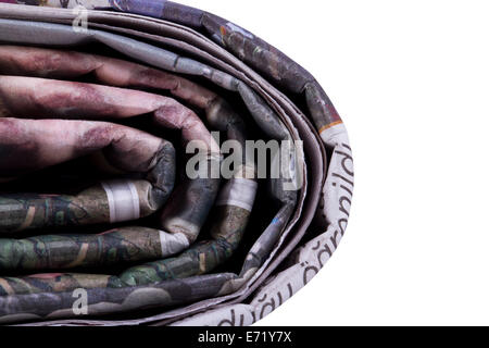 Corner of stacked newspapers, isolated on white background. Stock Photo