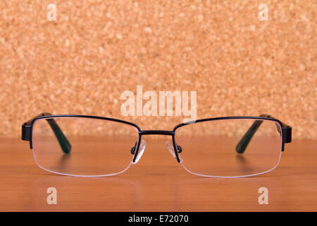 Eyeglasses on wooden table. Stock Photo