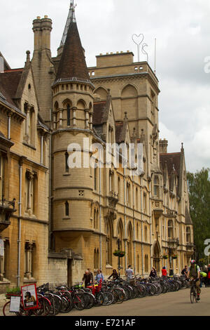 Ornate and historic buildings in Oxford, England with rows of bicycles ,used as popular urban transport , parked outside Stock Photo