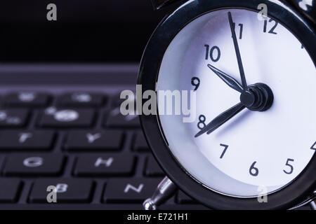 Deadline concept, alarm clock on laptop. Stock Photo
