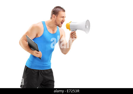 Male fitness coach shouting through a megaphone isolated on white background Stock Photo