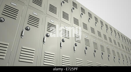 A perspective view of a stack of metal school lockers with combination locks and doors shut on an isolated background Stock Photo