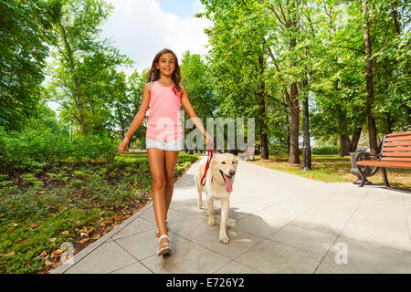 Beautiful teenage girl walking her dogs Stock Photo