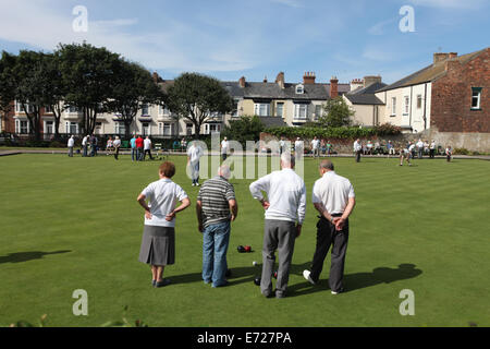 A group of older people playing crown green bowls. Stock Photo