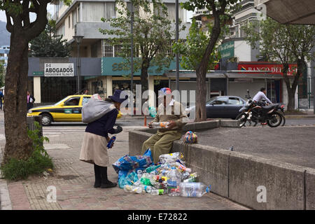 People collecting plastic bottles for recycling on Amazonas Avenue in the tourist district La Mariscal in Quito, Ecuador Stock Photo