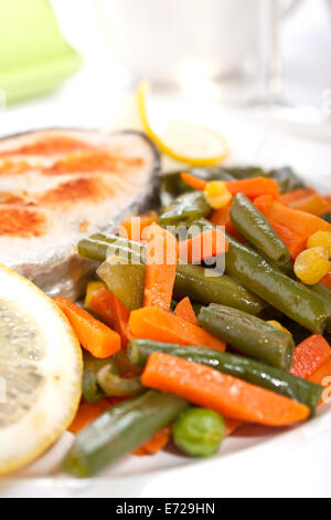 Grilled Salmon Steak with Vegetables and Lemon Stock Photo