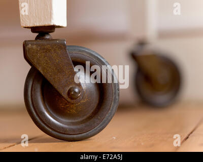 Swivel wheels of wooden serving trolley Stock Photo