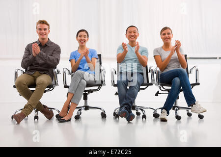 Successful executives applauding office Stock Photo