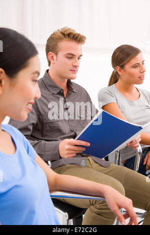 Confident businessman sitting with his colleagues in office Stock Photo