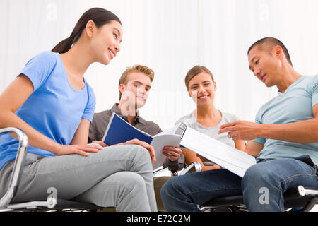 Executives discussing papers meeting Stock Photo
