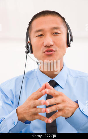 Close-up of male customer service representative wearing headset Stock Photo