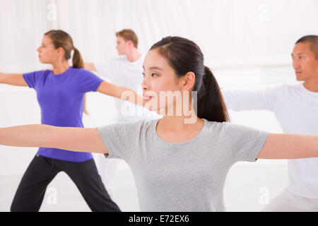 Sporty woman stretching her hands yoga class in fitness studio Stock Photo