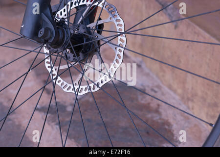 A large front disk brake on a top end Specialized mountain bike. Stock Photo