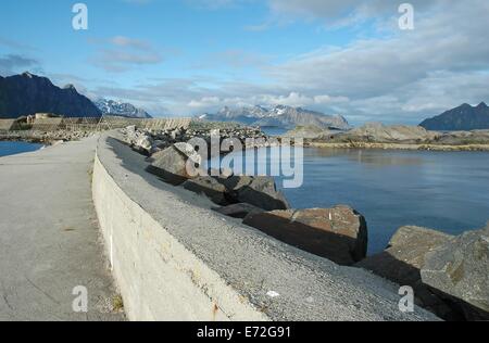pier with Racks full of dried codfish and mountains on background. Kjeoya, Svolvaer, Lofoten, Norway Stock Photo