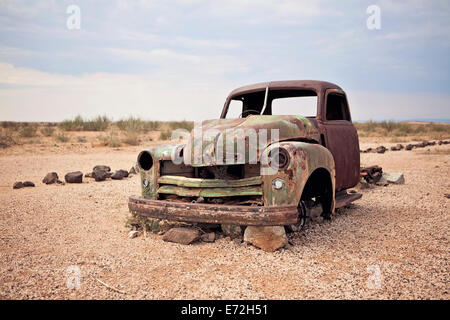 A rusty abandoned truck sits in the middle of the desert near Aus, Namibia. Stock Photo