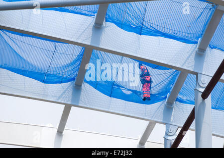 Worker on safety netting on the new roof which is being constructed at Victoria Station, Manchester, England, UK Stock Photo