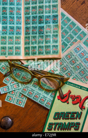 Catching up filling books with S&H Green Stamps in the 1950s. Stock Photo