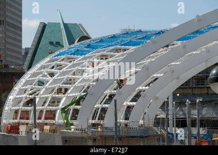 Worker on an access platform working on the new roof being constructed at Victoria Station, Manchester, England, UK Stock Photo