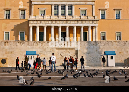 Tourists in front of the monument of the Unknown Soldier in front of the Greek Parliament, Syntagma square, Athens, Greece. Stock Photo