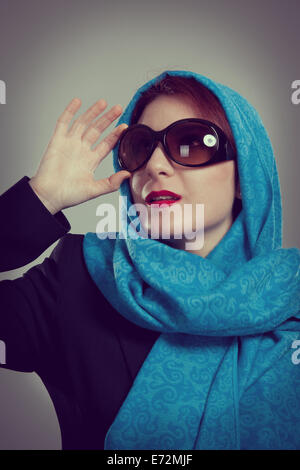 Elegant young woman wearing sun glasses. Studio shoot Stock Photo