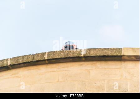 CARDIFF, UK. 4th September 2014. A protest against the NATO Summit takes place along Queen Street in the city centre, marching towards the castle where world leaders attended a dinner. A police officer is seen at the top of the RBS building with binoculars. Credit:  Polly Thomas/Alamy Live News Stock Photo