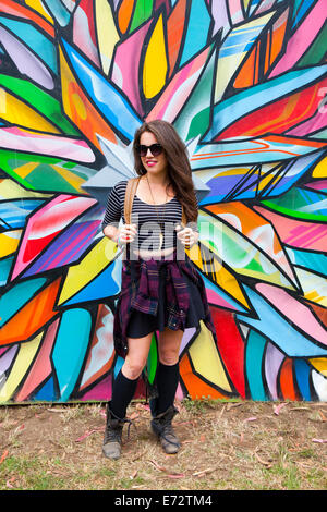 View of young young woman against graffiti on wall Stock Photo