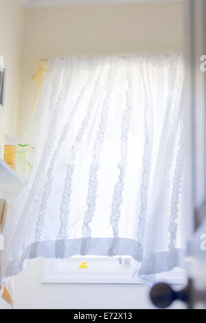 Window with white curtain in empty room Stock Photo