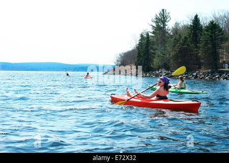 Women kayaking on lake Stock Photo
