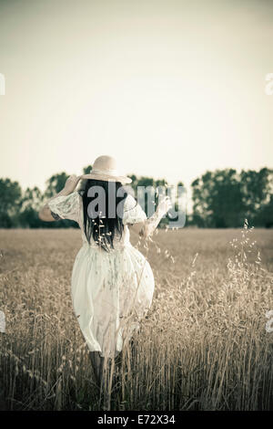 Rear view of young woman in meadow Stock Photo