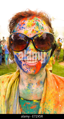 Portrait of woman covered with colorful paint Stock Photo