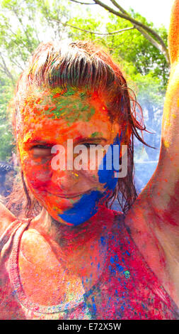 Portrait of woman covered with colorful paint Stock Photo