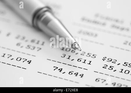 Financial statements. Ballpoint pen on financial statements. Black and white. SDOF. Closeup. Stock Photo