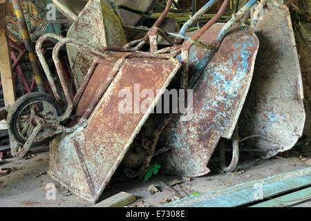 old wheel barrows for construction store at warehouse Stock Photo