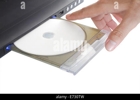 hand holding insert disk to dvd player isolated on white background Stock Photo