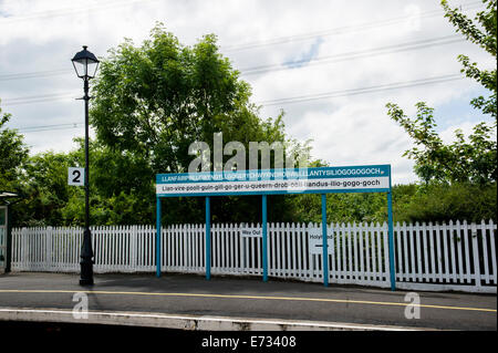 The sign at the train station at Llanfair the village with the longest place name in Europe in Anglesey in North Wales. Stock Photo