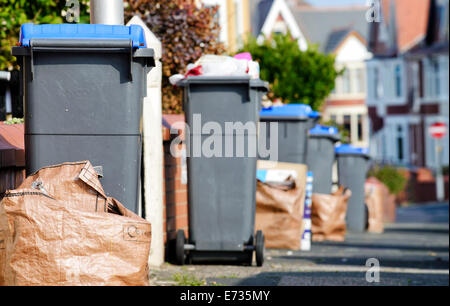 Wheelie bins containing glass and plastics and brown sacks with paper and cardboard, awaiting collection by Blackpool Council Stock Photo