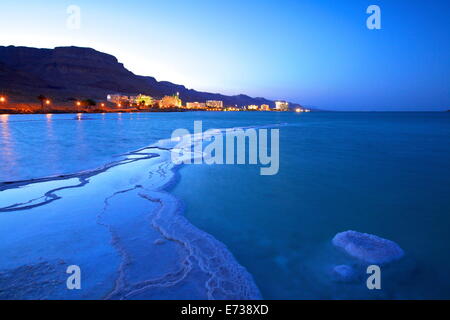 Salt deposit in foreground looking towards Ein Bokek, Ein Bokek, Dead Sea, Israel, Middle East Stock Photo