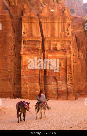 Bedouin riding donkey in the Siq, Petra, UNESCO World Heritage Site, Jordan, Middle East Stock Photo