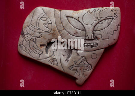A carved stone showing an astronaut, a face of an alien and spacecrafts is displayed in San Sebastian Bernal, Queretaro state, M Stock Photo