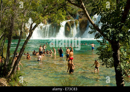 KRKA,CROATIA - AUGUST 2014. Tourists enjoy a bath at Krka waterfalls in Krka National park, great attraction near Sibenik. Stock Photo