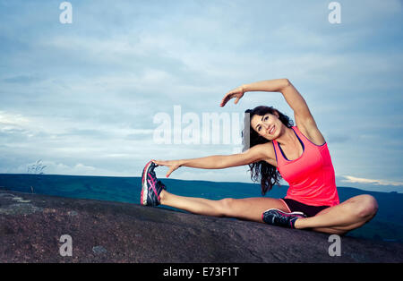 Woman performing warm up stretch Stock Photo