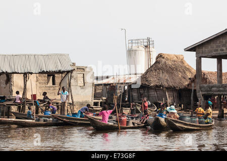 Africa, Benin, Ganvie. Locals gathered to fill containers from the community's water source. Stock Photo
